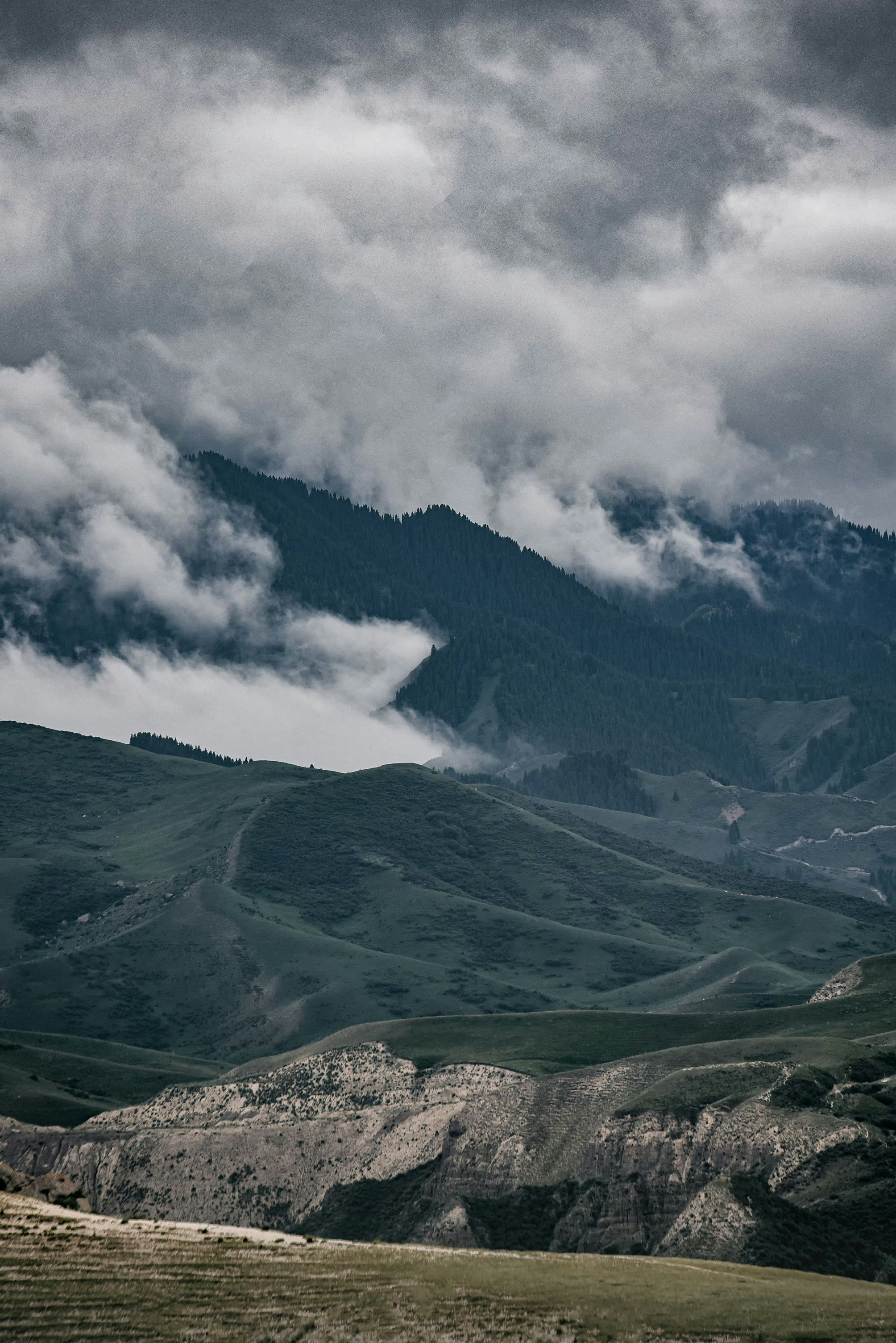 green mountains under white clouds during daytime